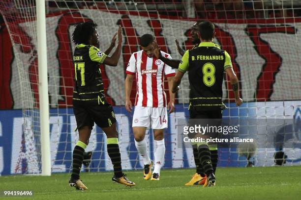 Sporting Lisbon's Gelson Martins celebrates with a teammate after scoring during the UEFA Champions League Group D football match between Olympiacos...