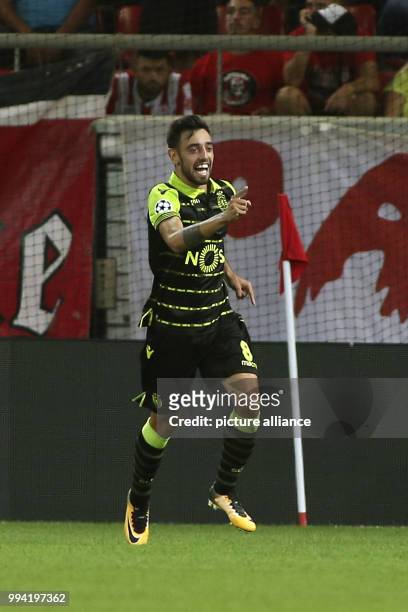 Lisbon's Bruno Fernandes celebrates after scoring the 0-3 during a Group D, UEFA Champions League football match between Olympiacos and Sporting...