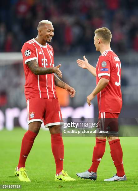 Muenchen's Jerome Boateng and Joshua Kimmich celebrate Kimmich's 3-0 goal during the Champions League Group B match between Bayern Muenchen and RSC...