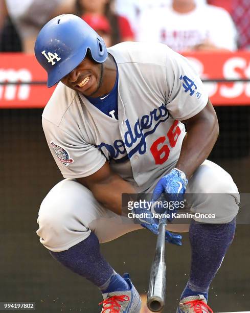 Yasiel Puig of the Los Angeles Dodgers reacts after sustaining a right intercostal oblique strain in the fifth inning, forcing him to leave the game...