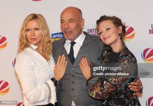 The actors Veronica Ferres , Heiner Lauterbach and Magdalena Boczarska attend the film premiere 'Unter deutschen Betten' at the Mathaeser Film Palace...