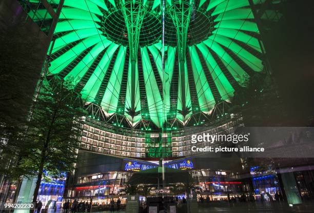 The roof of the Sony Center is illuminated in green in the evening in Berlin, Germany, 12 September 2017. The visitors can gaze at the different...