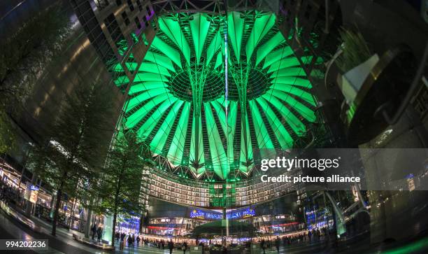 The roof of the Sony Center is illuminated in green in the evening in Berlin, Germany, 12 September 2017. The visitors can gaze at the different...