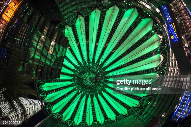 The roof of the Sony Center is illuminated in green in the evening in Berlin, Germany, 12 September 2017. The visitors can gaze at the different...