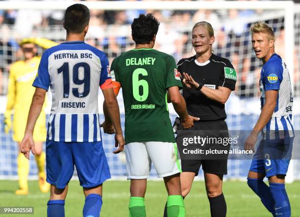 Referee Bibiana Steinhaus talks to Hertha's Vedad Ibisevic and Niklas Stark as well as Bremen's Thomas Delaney during the German Bundesliga soccer...