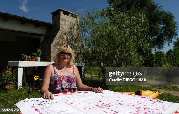 Argentine environmentalist Sofia Gatica shows a map of Cordoba's Ituzaingo neighborhood with cases of illnesses related to intoxications with...