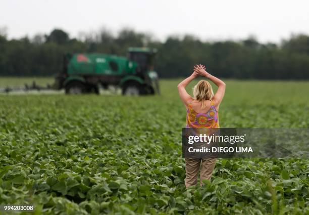 Argentine environmentalist Sofia Gatica tries to stop the spraying at a soybean field in Dique Chico, Cordoba province, Argentina, on January 20,...