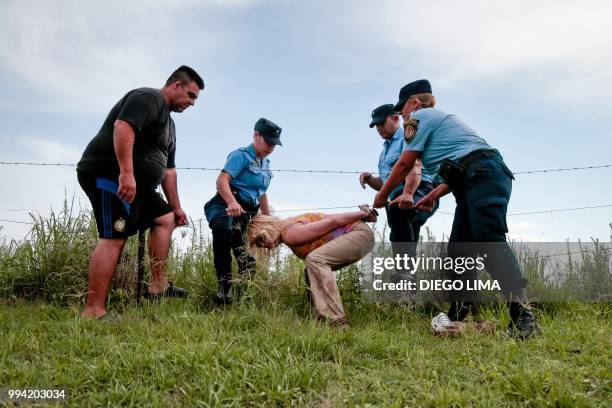 Argentine environmentalist Sofia Gatica is arrested by police officers after trying to stop the spraying at a soybean field in Dique Chico, Cordoba...