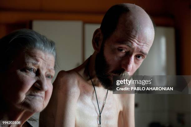 Argentinian former farmworker Fabian Tomasi and his mother Nelida Beatriz Obispo remain at their house during an interview with AFP in Basavilbaso,...