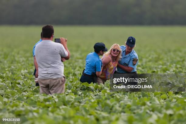 Argentine environmentalist Sofia Gatica is arrested by police officers as a farmer records the action on video after she tried to stop the spraying...