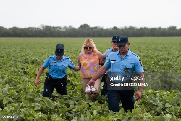 Argentine environmentalist Sofia Gatica is arrested by police officers after trying to stop the spraying at a soybean field in Dique Chico, Cordoba...