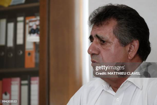 Head of the Turkish Cypriot Teachers Unionin Sener Elcil speaks at his desk during an interview in Nicosia, in the self-proclaimed Turkish Republic...