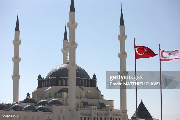 This picture shows the Turkish and self-proclaimed Turkish Republic of Northern Cyprus flags by the Hala sultan mosque in Haspolat , in the...