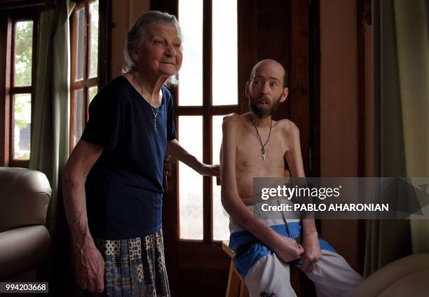 Argentinian former farmworker Fabian Tomasi and his mother Nelida Beatriz Obispo remain at their house during an interview with AFP in Basavilbaso,...