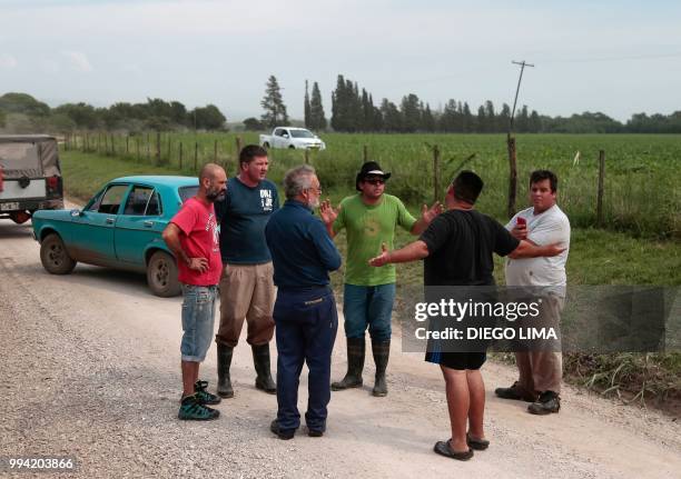 Farmers argue with field owner Alejandro Dalmasso after Argentine environmentalist Sofia Gatica tried to stop the spraying in Dique Chico, Cordoba...