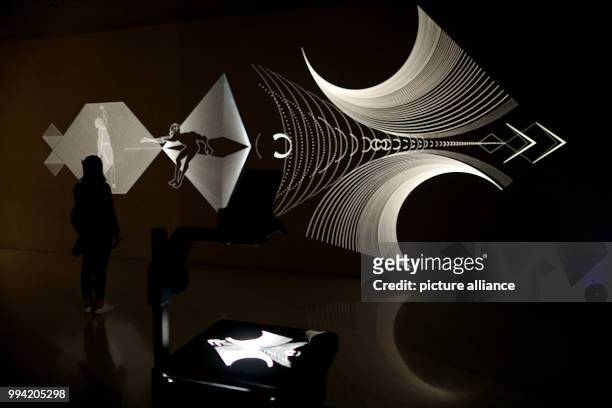 Woman stands in front of the projection 'Chronhomme' by Annamaria and Marzi Sala at the Kolumba Museum in Cologne, Germany, 13 September 2017. Once a...
