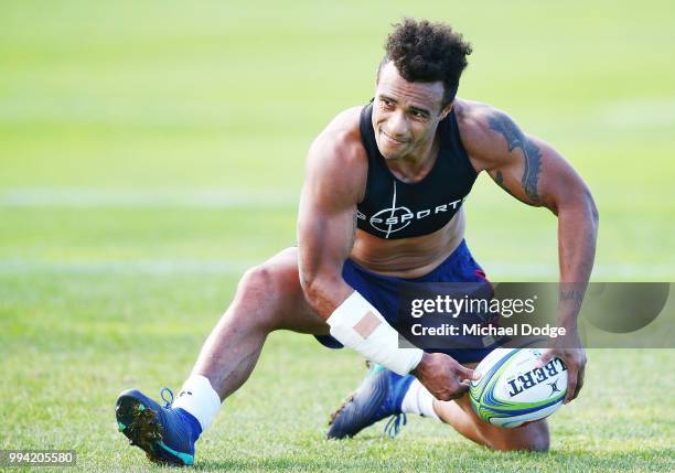 Will Genia of the Rebels, wearing a cast on his injured arm, passes the ball while taking part in his fitness test during a Melbourne Rebels Super...