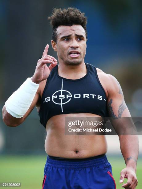 Will Genia of the Rebels, wearing a cast on his injured arm, gestures while taking part in his fitness test during a Melbourne Rebels Super Rugby...