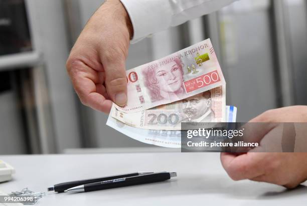 Notes of different European currencies , Swedish Krona, Croatian Kuna and Danish Krone, can be seen at a exchange office in Munich, Germany, 13...
