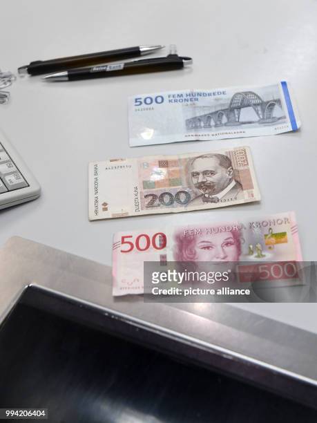 Notes of different European currencies , Danish Krone, Croatian Kuna and Swedish Krona, can be seen at a exchange office in Munich, Germany, 13...