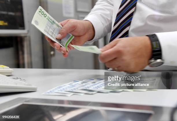 An employsee counts Danish Krone at an exchange office in Munich, Germany, 13 September 2017. President of the European Commission Juncker wants to...