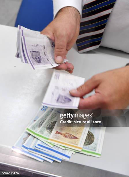 An employsee counts Danish Krone at an exchange office in Munich, Germany, 13 September 2017. President of the European Commission Juncker wants to...