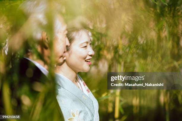 asian couple of gray hair senior and kimono woman who are walking in bamboo grove - masafumi nakanishi imagens e fotografias de stock