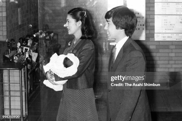 Prince Takamado and Princess Hisako of Takamado holding her second daughter Tsuguko leave Aiiku Hospital on March 14, 1986 in Tokyo, Japan.