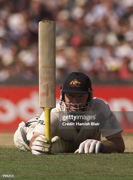 Steve Waugh of Australia celebrates 100, diving for his ground, during day two of the Fifth Test between England and Australia, at The Oval, London,...