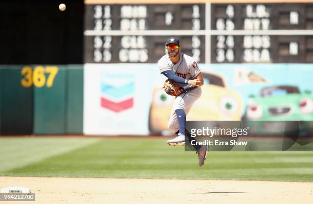 Carlos Correa of the Houston Astros throws to first base against the Oakland Athletics at Oakland Alameda Coliseum on June 14, 2018 in Oakland,...