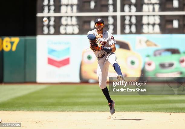 Carlos Correa of the Houston Astros throws to first base against the Oakland Athletics at Oakland Alameda Coliseum on June 14, 2018 in Oakland,...