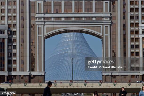 The Khan Shatyr Entertainment Center seen through the arch of the headquarters of KazMunayGas in Astana, capital city of Kazakhstan, 2016.