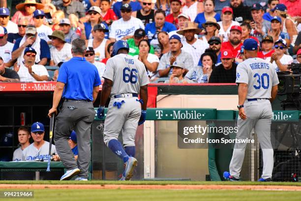 Los Angeles Dodgers right fielder Yasiel Puig is removed from the game by the trainer and manager Dave Roberts during a MLB game between the Los...