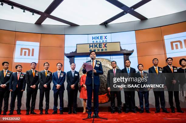 Xiaomi founder, chairman and CEO, Lei Jun , gestures as he reads a speech at the company's initial public offering launch on the Hong Kong Stock...