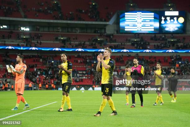 Dortmund's Roman Bürki , Pierre-Emerick Aubameyang, Lukasz Piszczek, Christian Pulisic, Neven Subotic, Sokratis and Shinji Kagawa thank their team's...