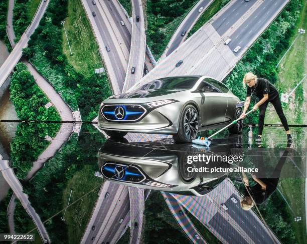 Worker sweeps the floor in front of a Mercedes EQ Aconcept e-car at the opening of the International Automobile Exhibition in Frankfurt am Main,...