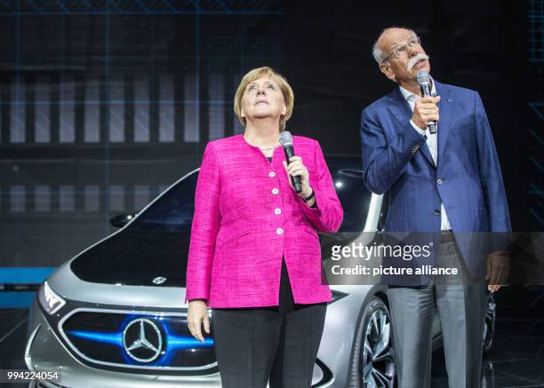 Dpatop - German chancellor Angela Merkel with Daimler CEO Dieter Zetsche in front of a Mercedes EQ A concept e-car at the opening of the...