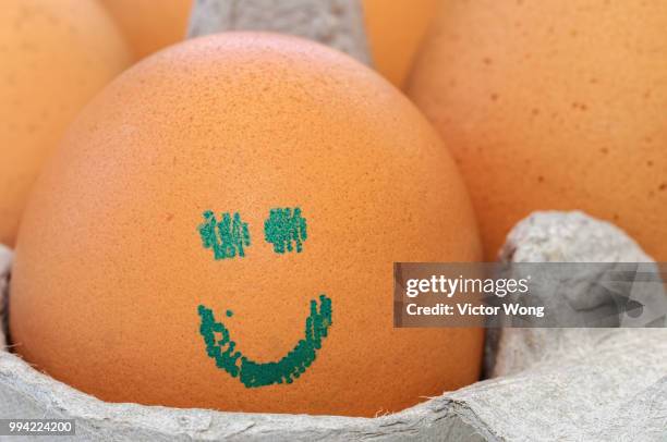 egg with imprinted smiley face - smiley face stock pictures, royalty-free photos & images