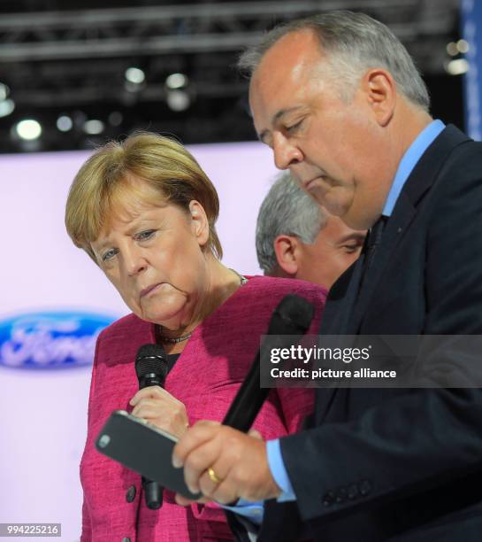 German chancellor Angela Merkel the head of the German branch of Ford, Gunnar Herrmann, at the Internationale Automobil-Ausstellung in Frankfurt am...