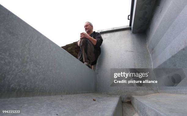 Farmer Herbert Siegel sits on his mobile slaughtering station in Missen, Germany, 21 August 2017. The station allows Siegel to slaughter his cows in...