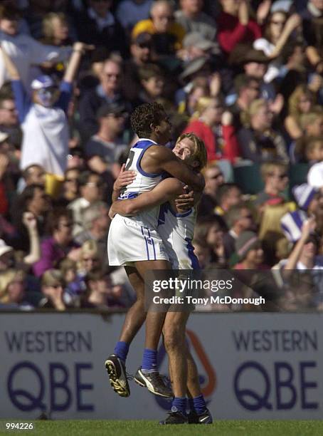 Byron Pickett and Jess Sinclair for the Kangaroos hug after a goal during the match between the West Coast Eagles and the Kangaroos during round 15...