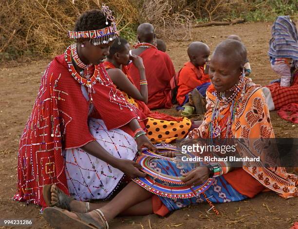 Maasai women making colourful decorations in Kenya, 2016.
