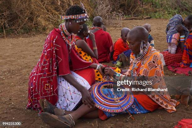 Maasai women making colourful decorations in Kenya, 2016.