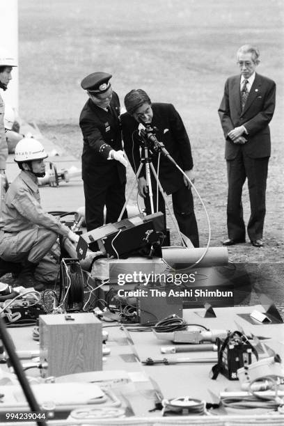 Crown Prince Akihito inspects the joint fire exercise in preparation for forming the International Rescue Team of Japan on April 11, 1986 in Tokyo,...