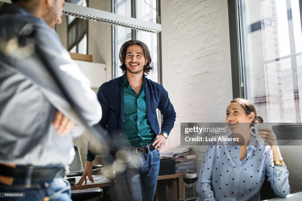 Colleagues discussing strategy during meeting