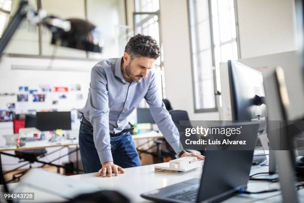 businessman analyzing architectural model on desk - technophile stock pictures, royalty-free photos & images