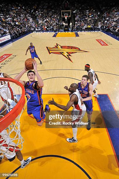 Danilo Gallinari of the New York Knicks goes up for a shot against Anthony Tolliver of the Golden State Warriors during the game at Oracle Arena on...