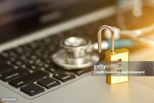 computer security concept. padlock on computer circuit board - data vulnerability stock pictures, royalty-free photos & images