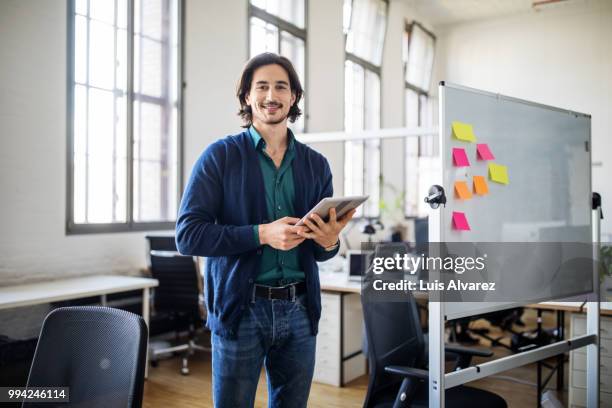 handsome businessman standing with digital tablet - multi colored shirt foto e immagini stock