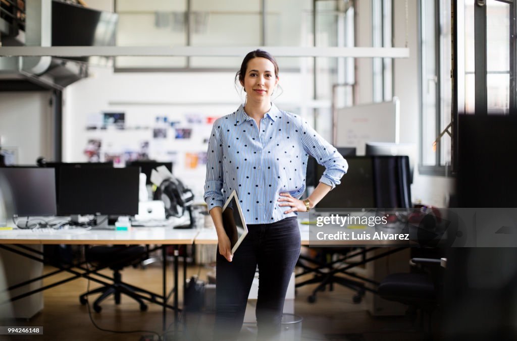 Businesswoman standing with digital tablet